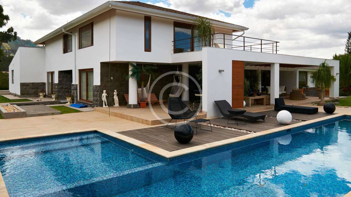 Geometric pool design using brick with gazebo & decorative lighting